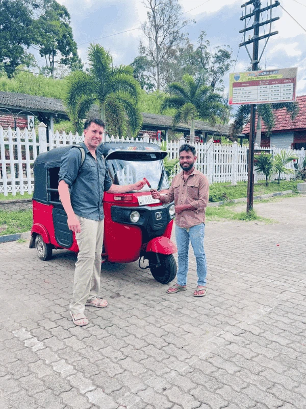 Manoj Fernando, founder of Tuk Tuk Rental Negombo, with a red tuk tuk in Negombo, Sri Lanka