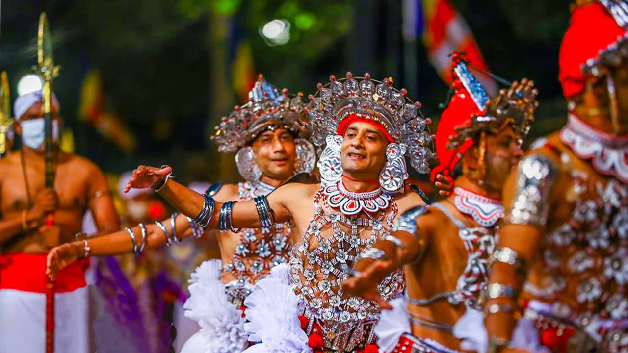 Kandy Esala Perahera procession with elephants and fire dancers at night