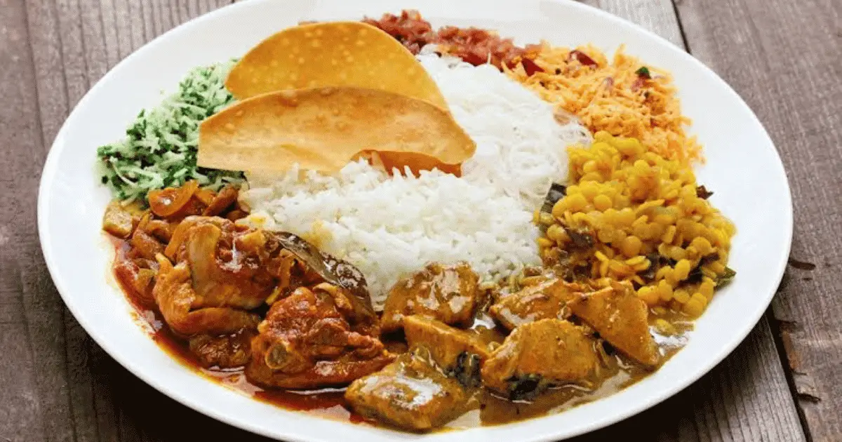Traditional Sri Lankan rice and curry — steamed rice served with dhal, fish curry, coconut sambol, and multiple side dishes